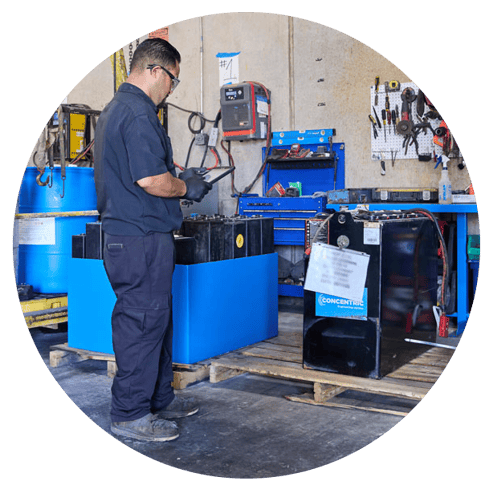 Concentric technician performing battery maintenance.